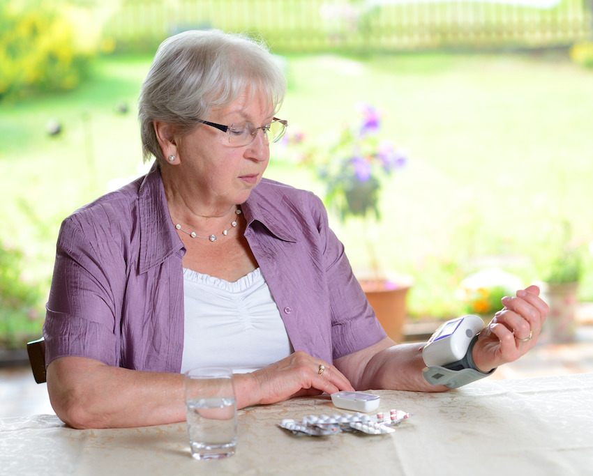 Older woman taking blood pressure