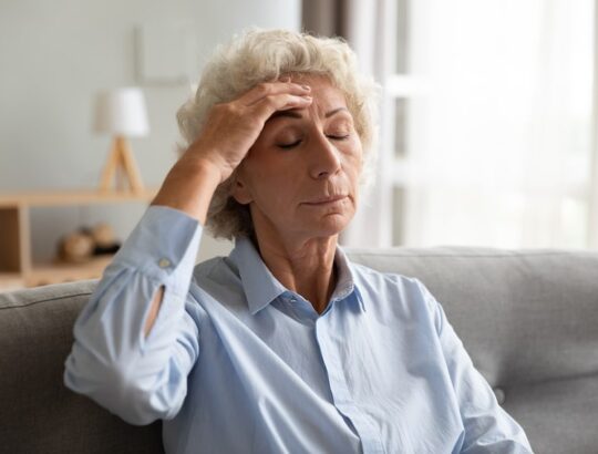 Older woman with dizziness due to high blood pressure