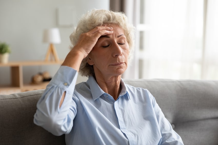 Older woman with dizziness due to high blood pressure